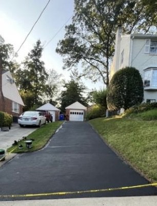 Freshly sealed driveway and tidy lawn in Arlington, VA by Martin & Margison Lawn Bros